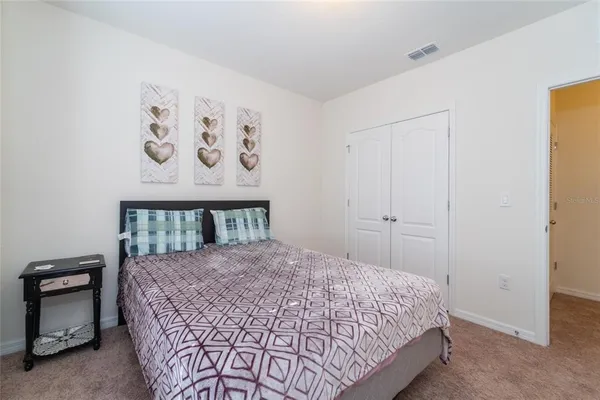 a large bed sitting in a bedroom next to a bathroom