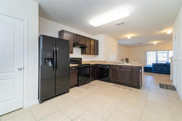 a kitchen with stainless steel appliances a refrigerator and a sink