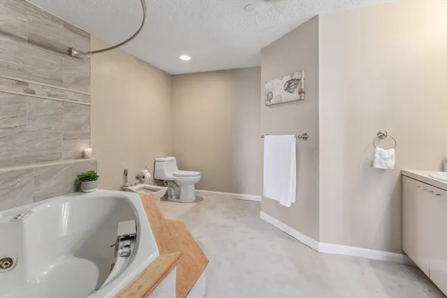 a bathroom with a tub sink and toilet