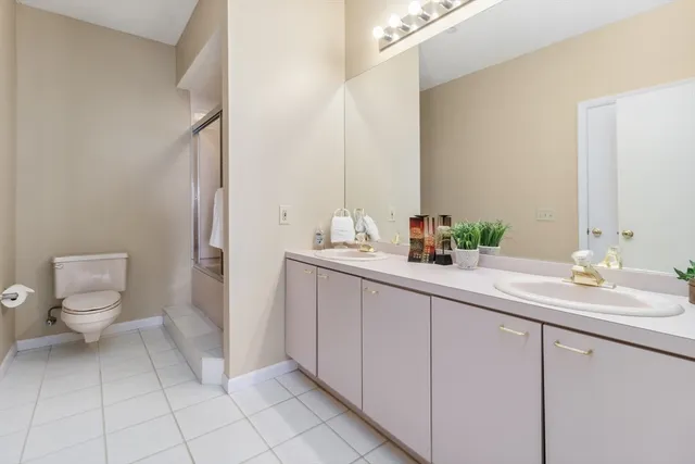 a bathroom with a sink a toilet and a mirror