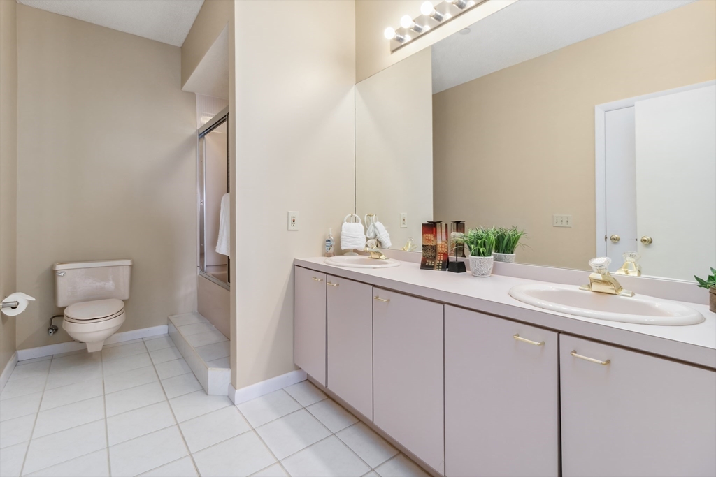 65 Lake Avenue, Unit 1008 Worcester, MA 01604 - Photo 17 of 35 a bathroom with a sink a toilet and a mirror