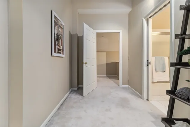 a view of a hallway with a livingroom and a window
