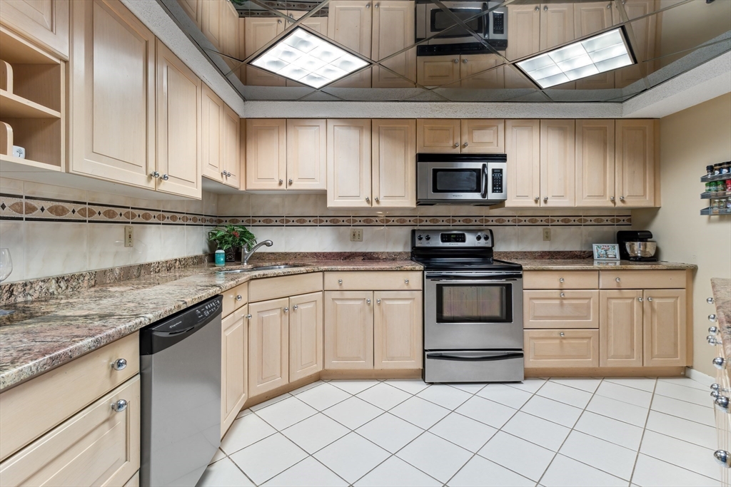 65 Lake Avenue, Unit 1008 Worcester, MA 01604 - Photo 8 of 35 a kitchen with granite countertop a sink stainless steel appliances and cabinets
