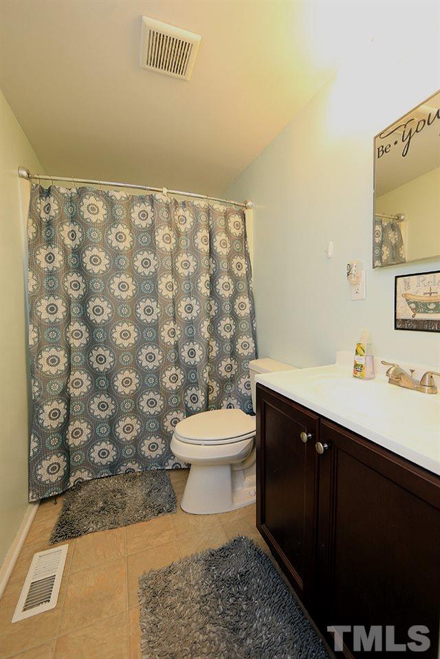 7705 Mourning Dove Road Raleigh, NC 27615 - Photo 6 of 14 a bathroom with a sink toilet and shower