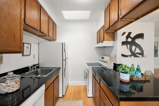 a bedroom with a bed and a potted plant