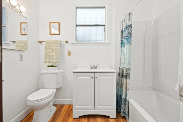 a bedroom with a bed and painting on the wall
