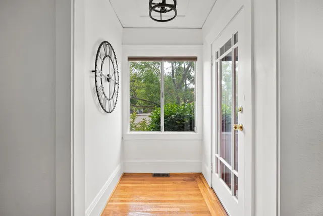 a living room with furniture a wooden floor and a window