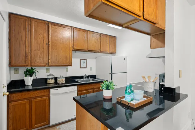 a kitchen with stainless steel appliances a counter space and a window