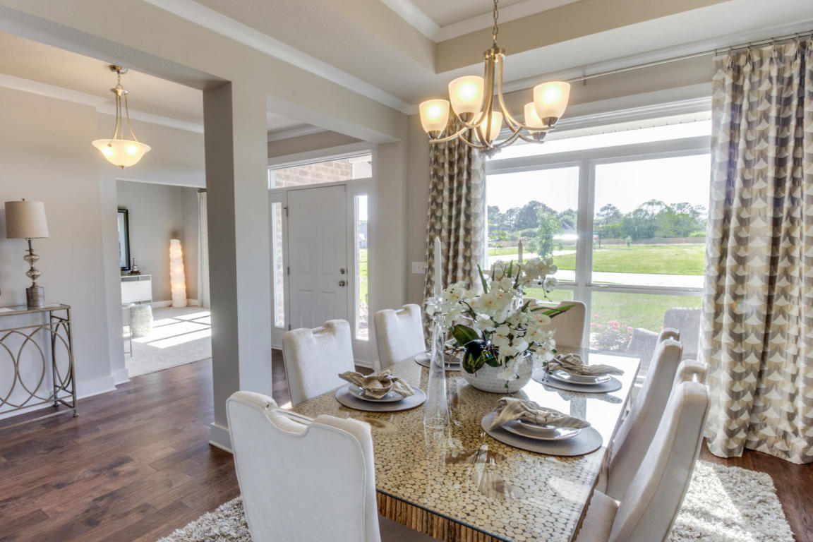 329 Merlin Court Crestview, FL 32539 - Photo 3 of 16 a dining room with furniture a chandelier and wooden floor