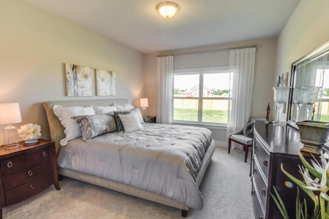 329 Merlin Court Crestview, FL 32539 - Photo 10 of 16 a bedroom with bed a bookshelf and a window