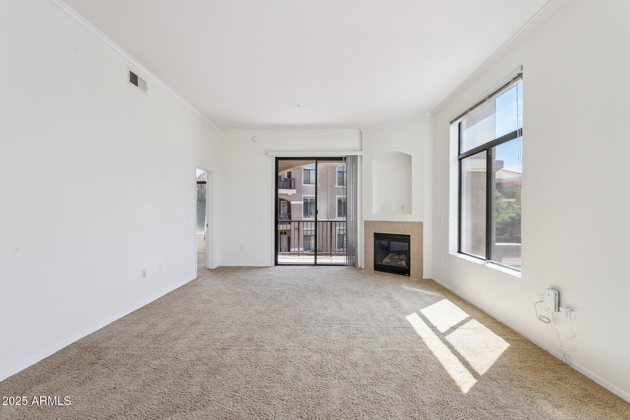 11640 North Tatum Boulevard, Unit 2079 Phoenix, AZ 85028 - Photo 16 of 48 a view of a livingroom with an empty space and a fireplace
