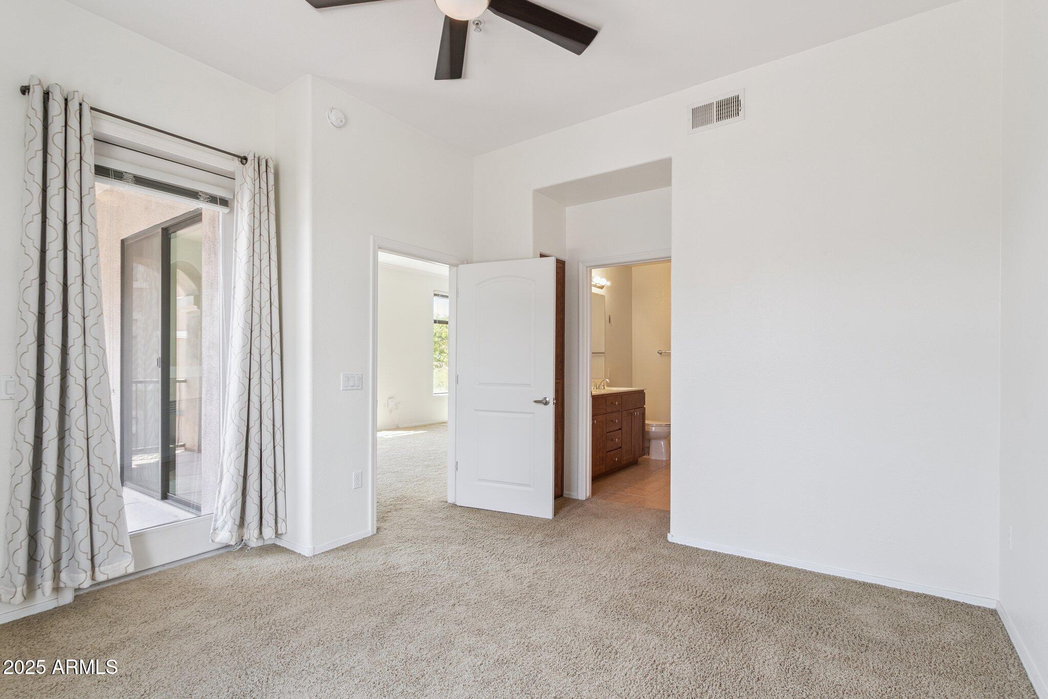 11640 North Tatum Boulevard, Unit 2079 Phoenix, AZ 85028 - Photo 22 of 48 an empty room with closet and a hallway