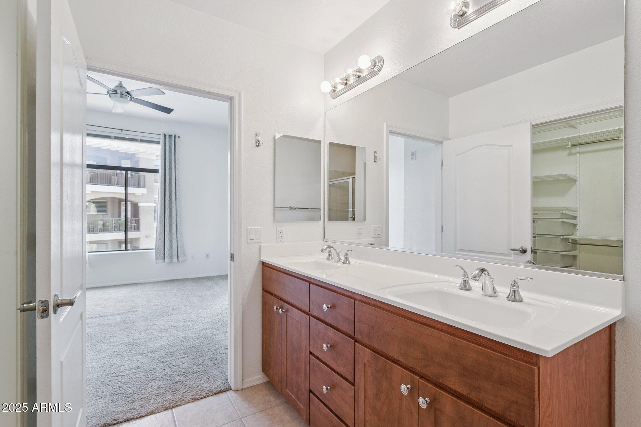11640 North Tatum Boulevard, Unit 2079 Phoenix, AZ 85028 - Photo 24 of 48 a bathroom with double sink and a mirror