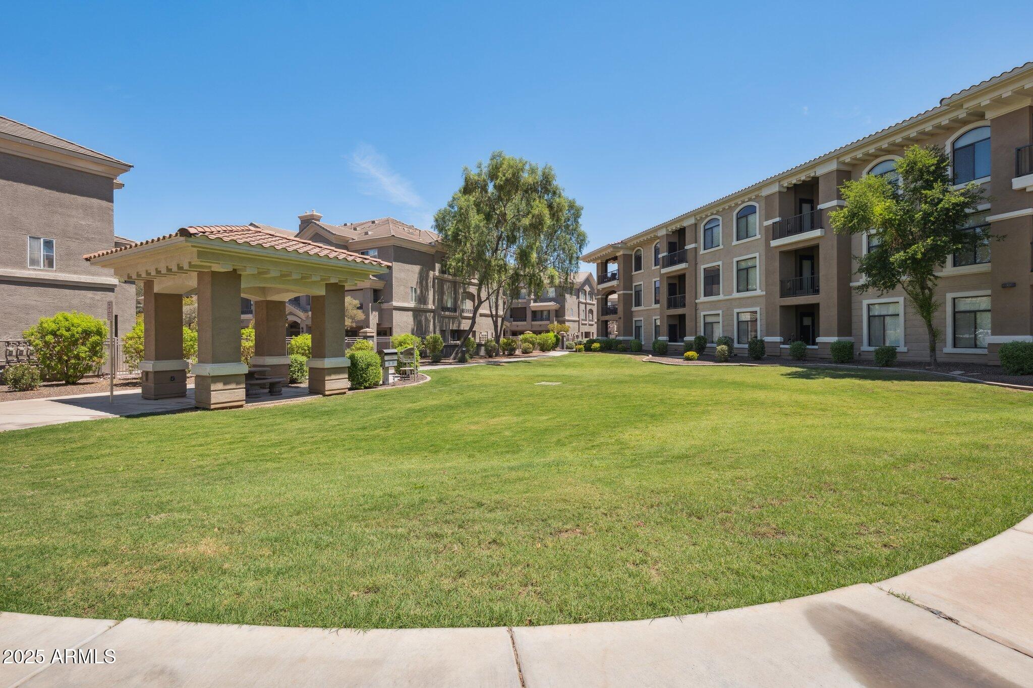 11640 North Tatum Boulevard, Unit 2079 Phoenix, AZ 85028 - Photo 44 of 48 a view of a big building with a big yard and large trees