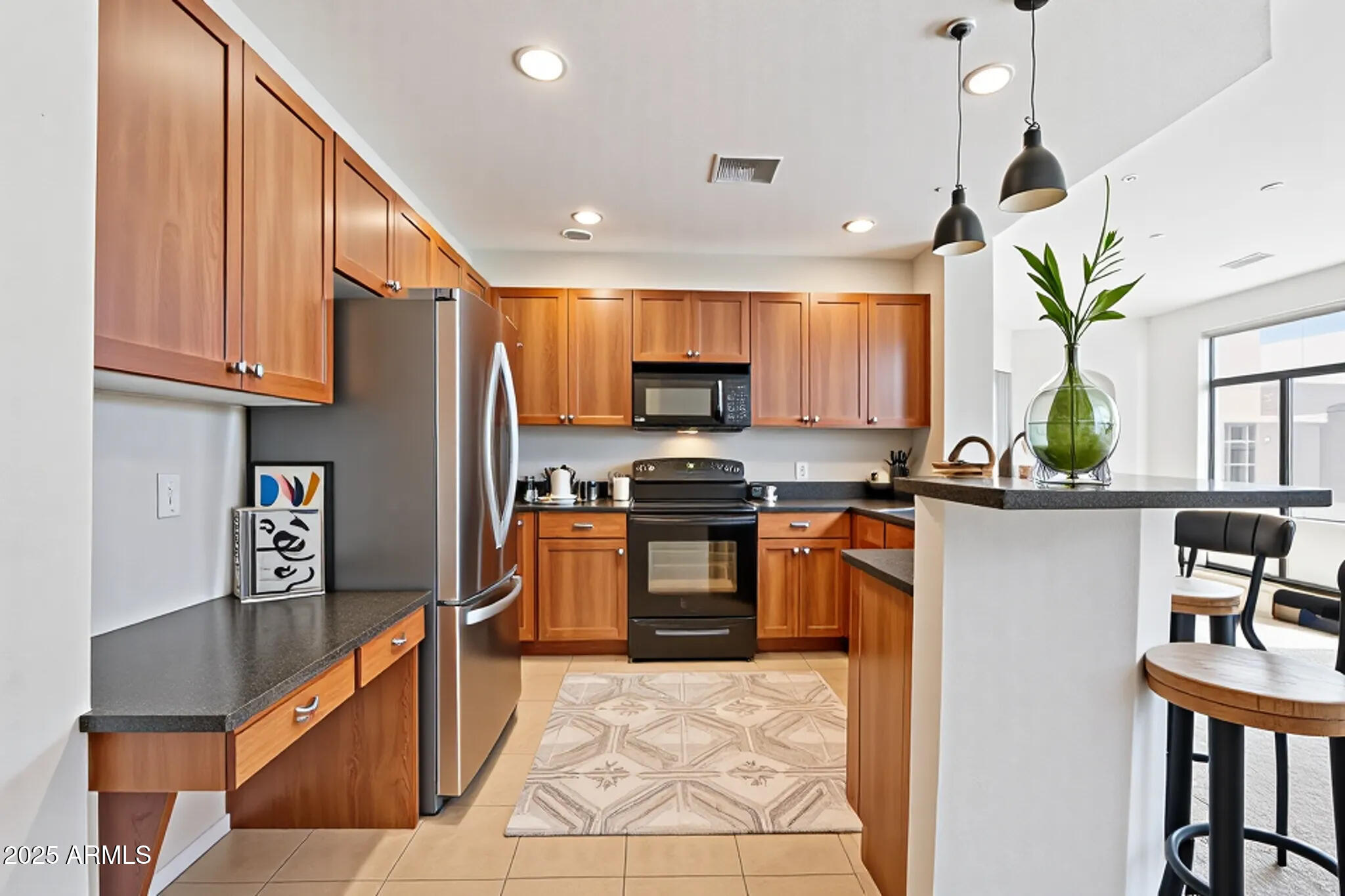 11640 North Tatum Boulevard, Unit 2079 Phoenix, AZ 85028 - Photo 6 of 48 a kitchen with stainless steel appliances granite countertop a refrigerator a stove a sink dishwasher and a microwave with wooden floor
