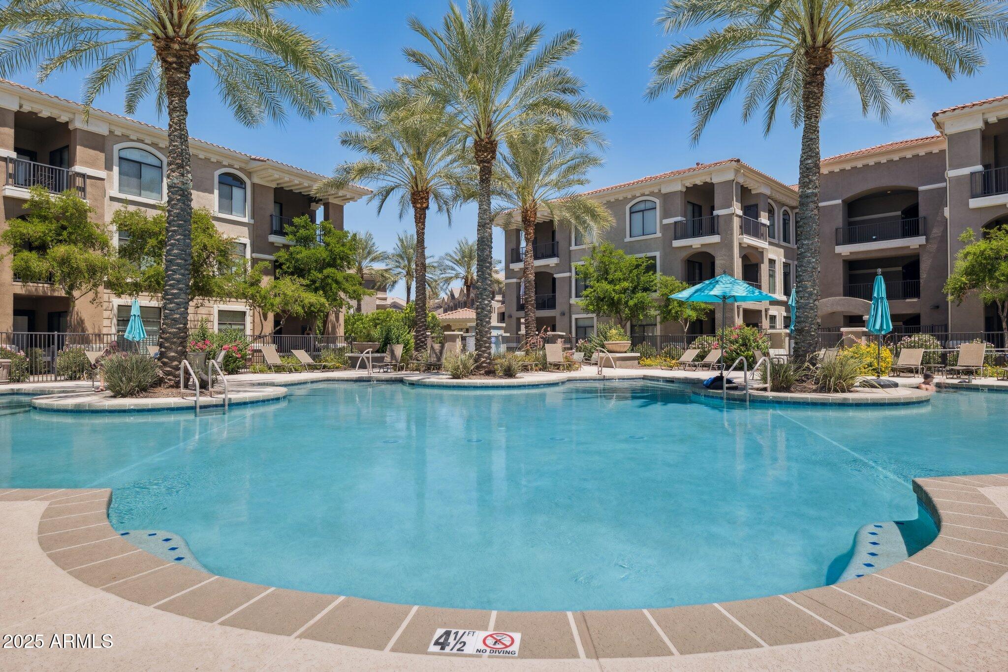 11640 North Tatum Boulevard, Unit 2079 Phoenix, AZ 85028 - Photo 8 of 48 a front view of a house with swimming pool and porch