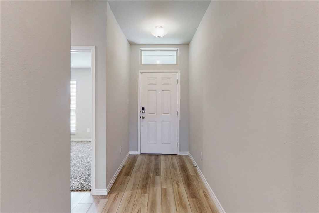 2010 Chief Street Bryan, TX 77807 - Photo 4 of 29 a view of a hallway with wooden floor and a bathroom
