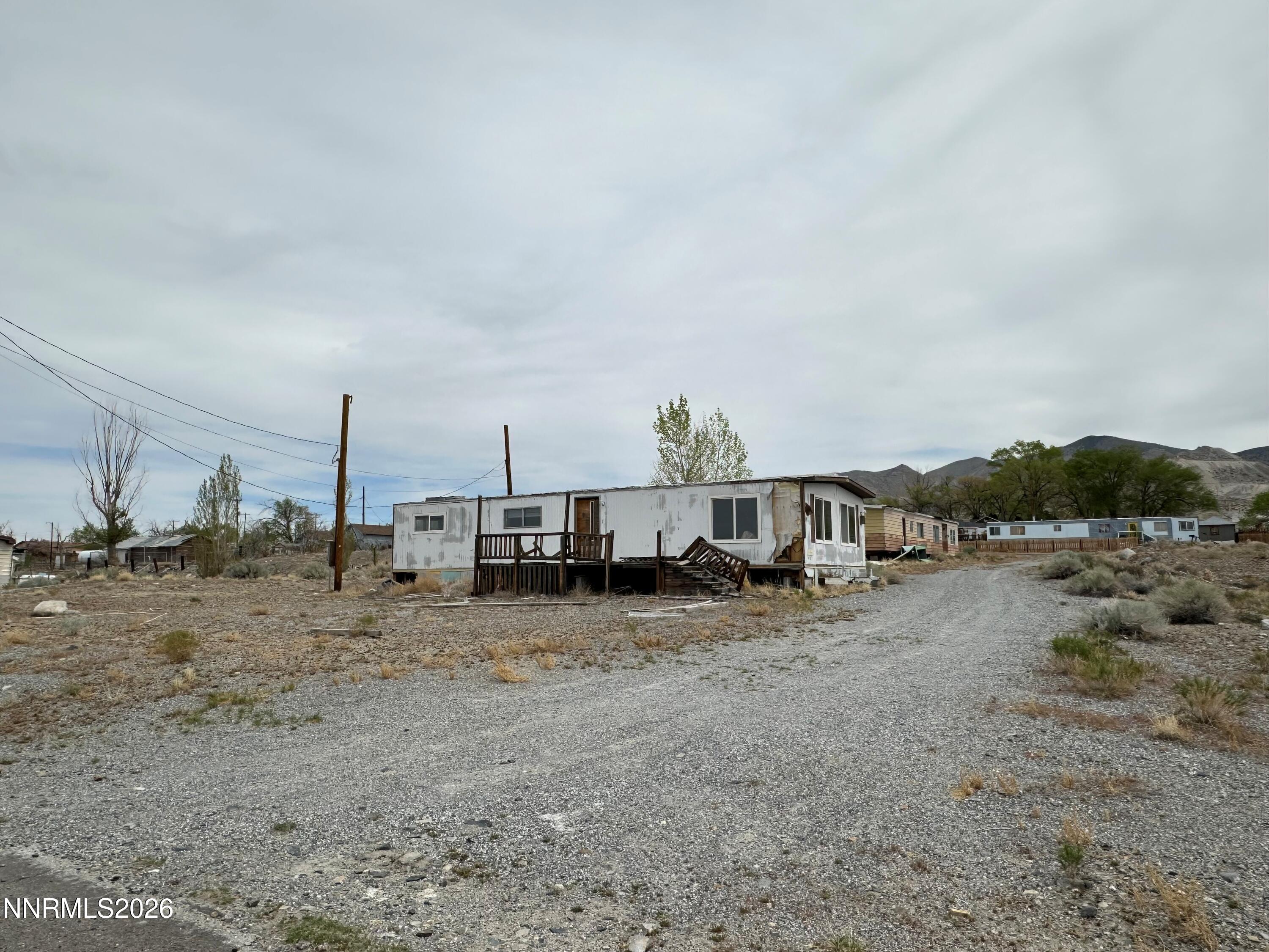 810 Church Street Gabbs, NV 89409 - Photo 2 of 3 a view of a dry yard with trees