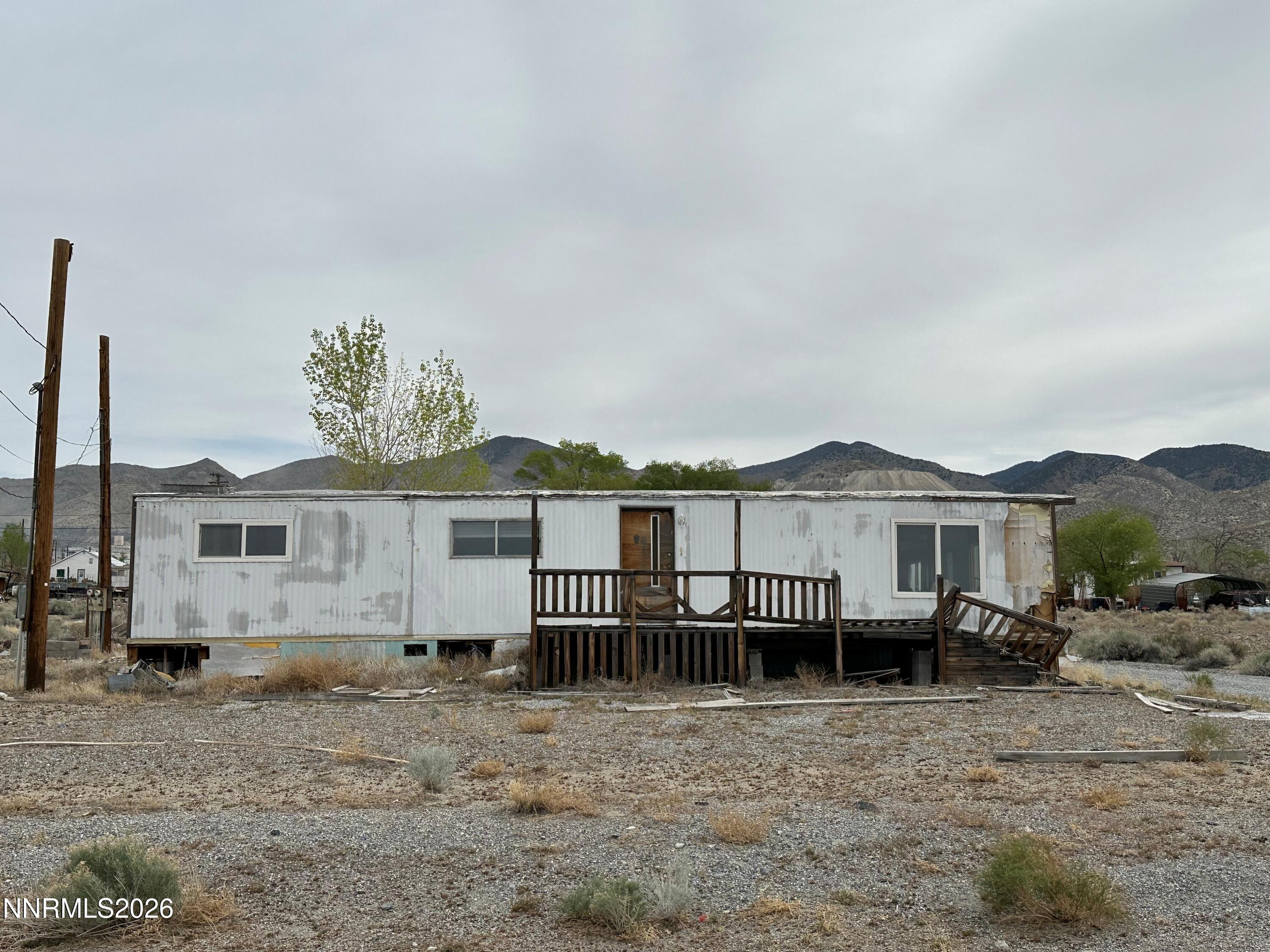 810 Church Street Gabbs, NV 89409 - Photo 3 of 3 a view of a house with a wooden deck and a yard