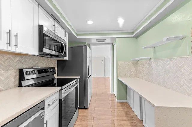 a kitchen with stainless steel appliances granite countertop a stove and a sink