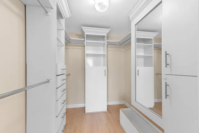 a view of walk in closet with empty racks