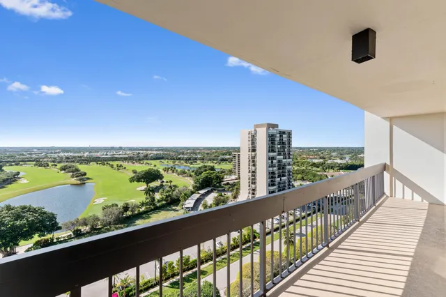 a living room with furniture a flat screen tv and a large window