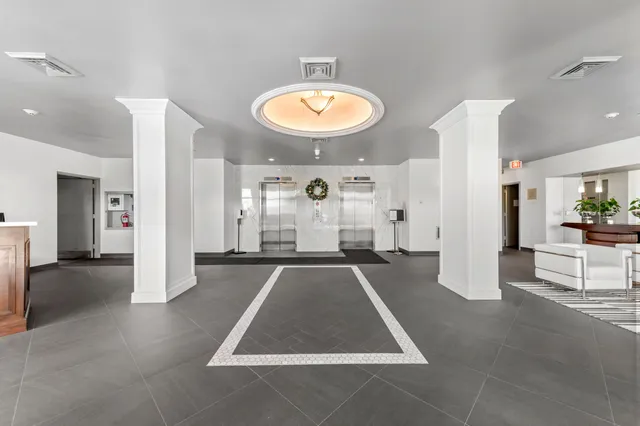 an entryway space with lots of furniture and a rug