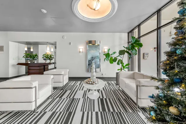 a living room with furniture and flowers