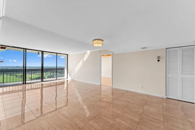 a view of empty room with floor to ceiling window