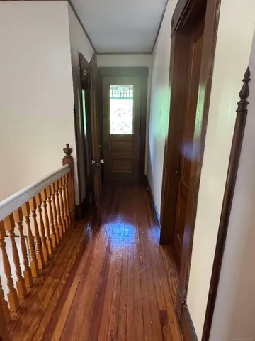 a view of hallway with wooden floor