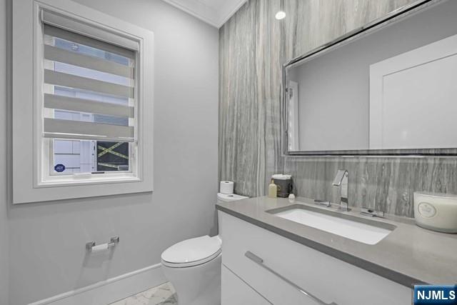 1234 River Road Edgewater, NJ 07020 - Photo 14 of 29 a bathroom with a granite countertop sink toilet and a mirror