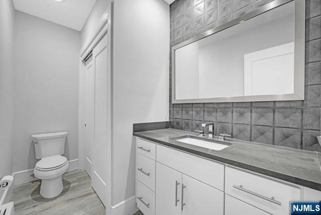 1234 River Road Edgewater, NJ 07020 - Photo 19 of 29 a bathroom with a granite countertop toilet sink and mirror