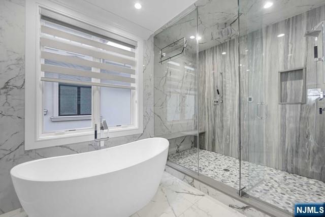 1234 River Road Edgewater, NJ 07020 - Photo 21 of 29 a white bath tub sitting next to a bathroom