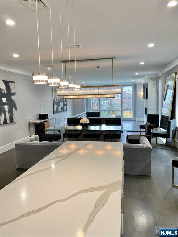 1234 River Road Edgewater, NJ 07020 - Photo 5 of 29 a living room with stainless steel appliances granite countertop furniture and a chandelier