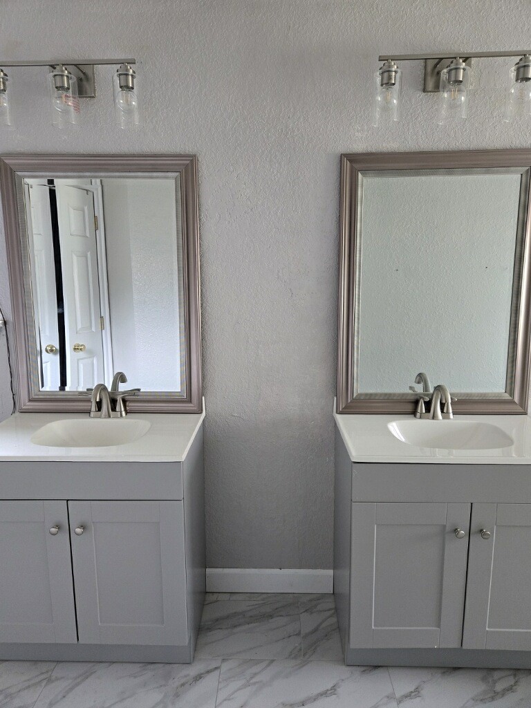 254 Maple Lane Conroe, TX 77304 - Photo 14 of 27 a bathroom with a sink and a mirror