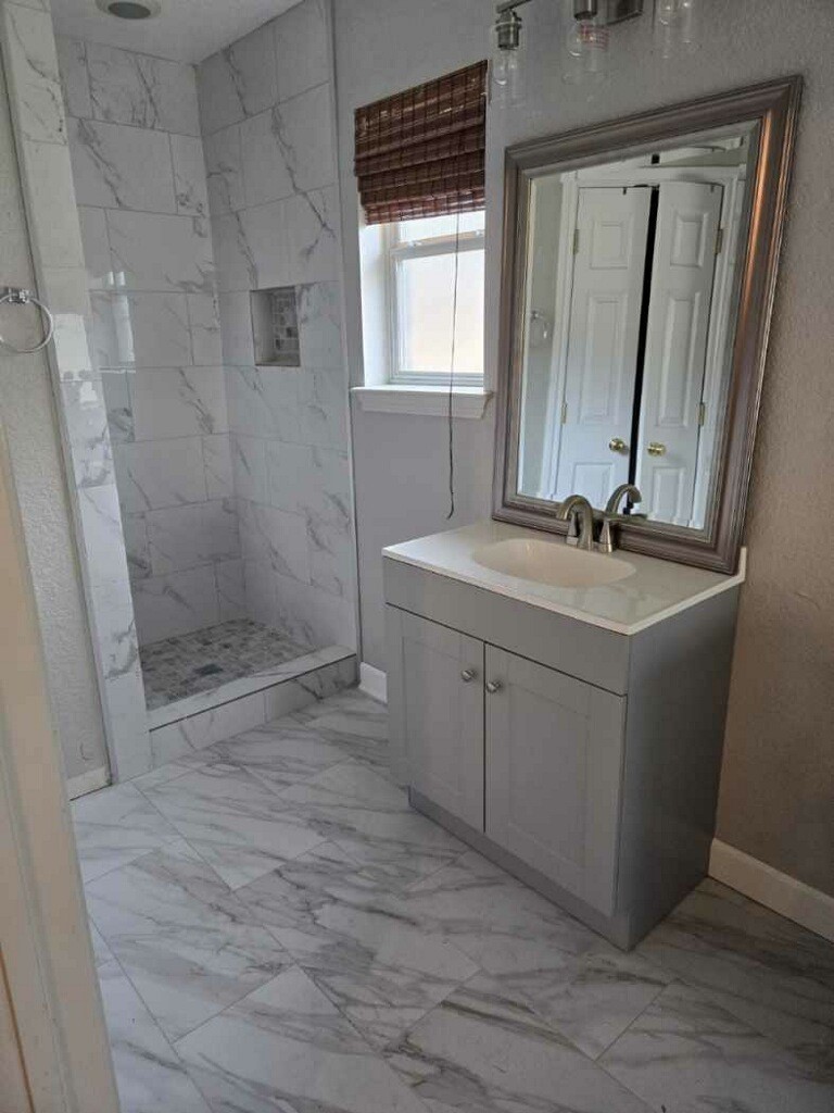 254 Maple Lane Conroe, TX 77304 - Photo 16 of 27 a bathroom with a sink toilet and shower