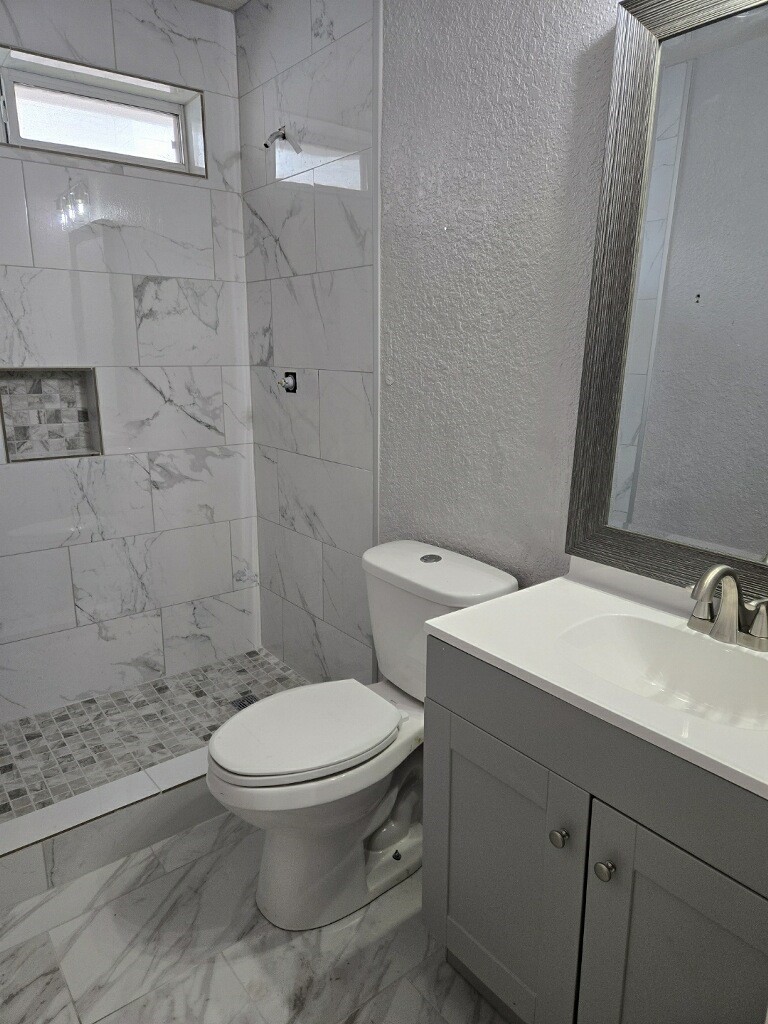 254 Maple Lane Conroe, TX 77304 - Photo 18 of 27 a bathroom with a sink a toilet and shower