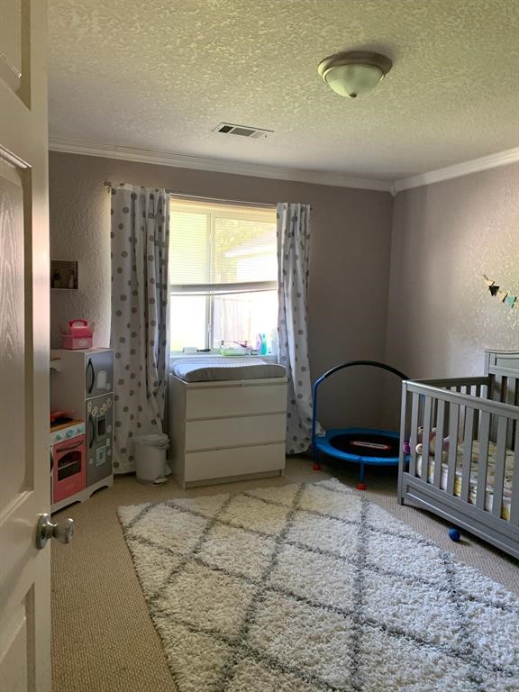 254 Maple Lane Conroe, TX 77304 - Photo 21 of 27 a bedroom with furniture and a window