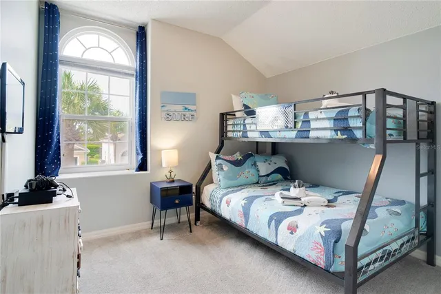 a bedroom with two beds and a chandelier