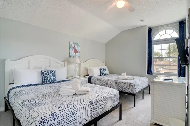 a bedroom with a bed and a table lamp