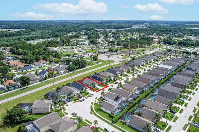 an aerial view of a house with a yard