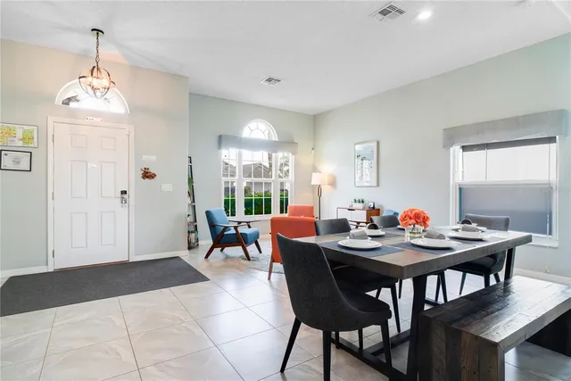 a view of a dining room with furniture and a chandelier