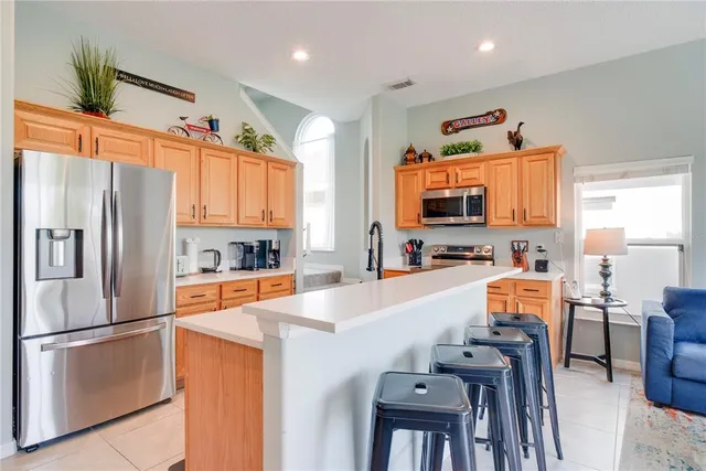 a kitchen with stainless steel appliances a refrigerator and a stove top oven