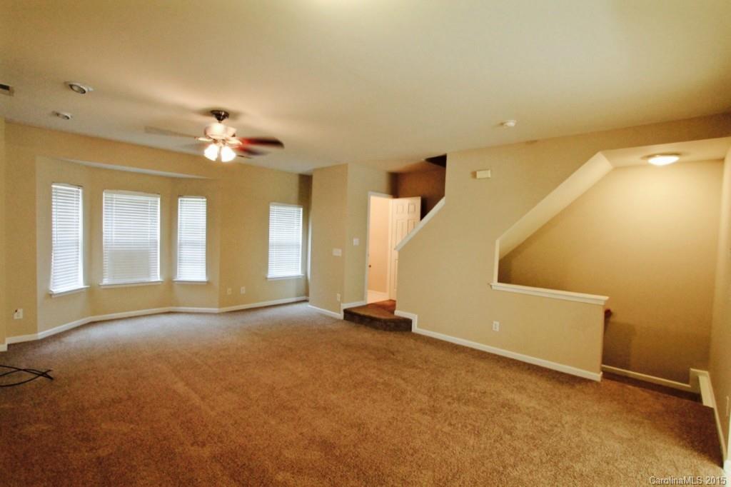 9738 Bailey Road, Unit 170 Cornelius, NC 28031 - Photo 4 of 10 wooden floor in an empty room with a window