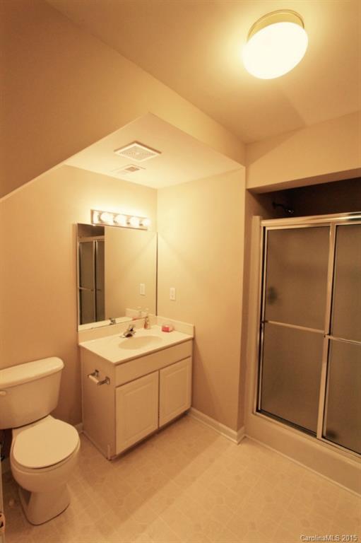 9738 Bailey Road, Unit 170 Cornelius, NC 28031 - Photo 7 of 10 a bathroom with a toilet sink vanity and mirror