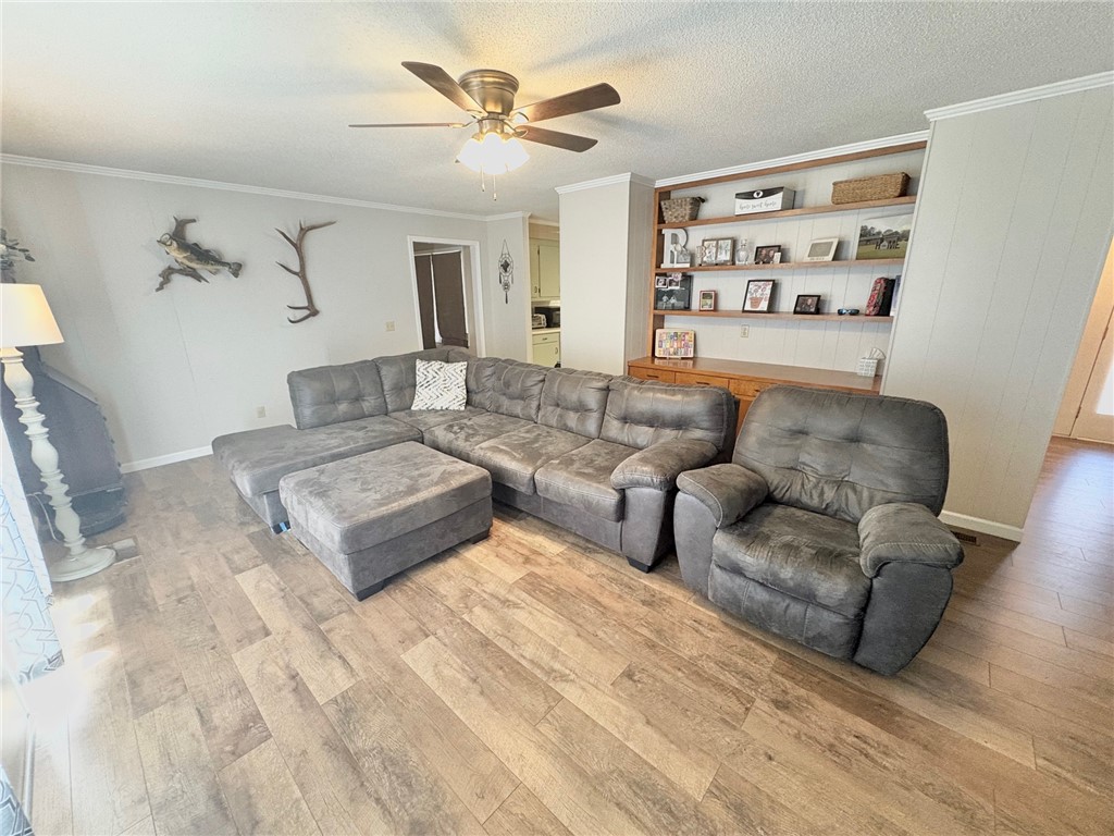 1404 Farrs Bridge Road Easley, SC 29640 - Photo 6 of 27 This living room features built-in shelving, crown molding, and durable hardwood flooring.