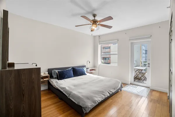 a bedroom with a bed and wooden floor