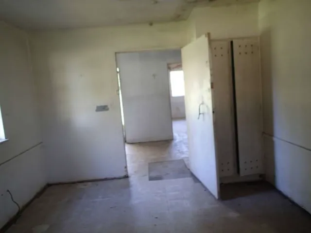 a view of a room with furniture and windows