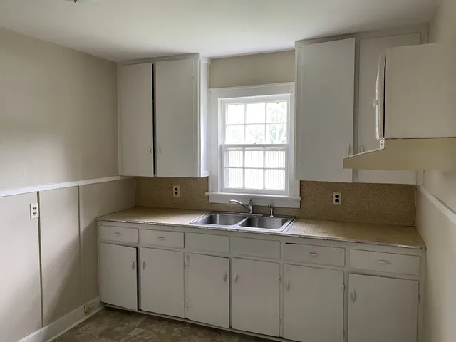 a kitchen with a sink and cabinets