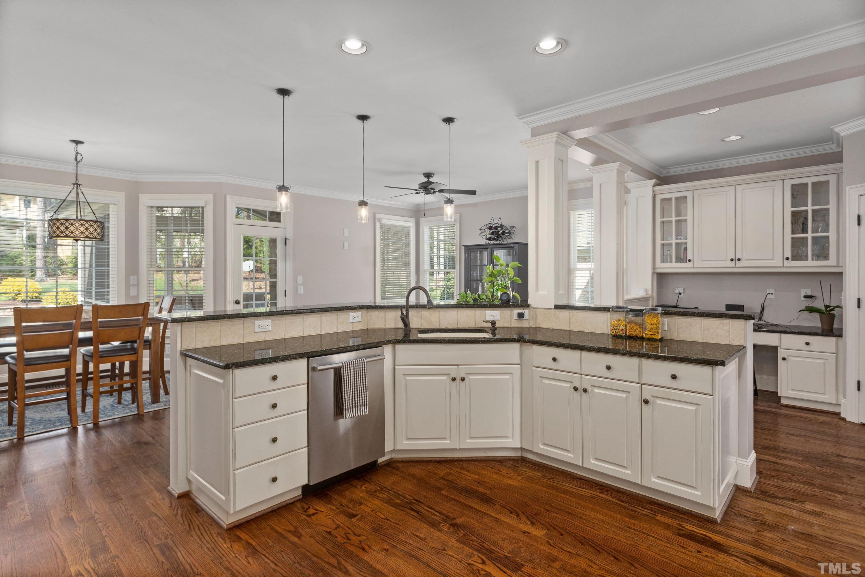 4324 Summer Brook Drive Apex, NC 27539 - Photo 11 of 70 a large kitchen with cabinets chairs and wooden floor